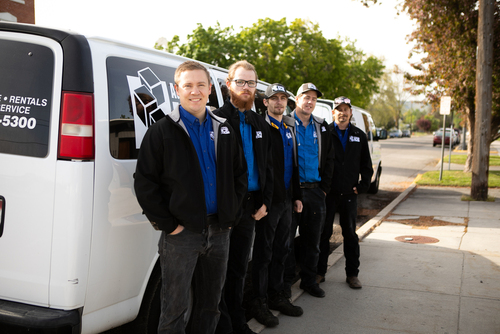 Company lined up beside company van